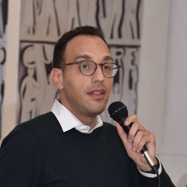 Ahmed Amine Azouzi speaking at an event.